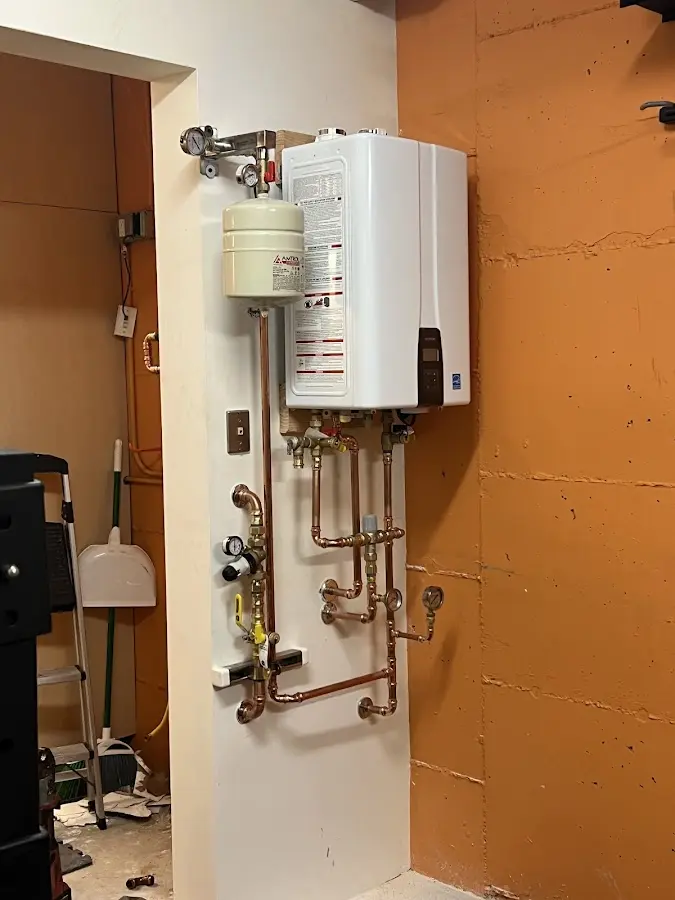 Plumbing technician inspecting water heater connections in Forest Acres